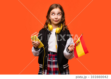 Girl holds small flag Spain 101660042