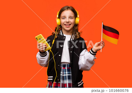 Girl holds small German flag 101660076