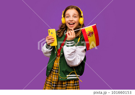 Girl holds small flag Spain 101660153