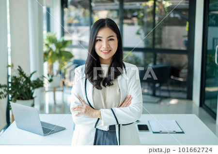 Asian woman entrepreneur with business success standing happily smiling in the office Asian woman entrepreneur with business success standing happily smiling in the office 101662724