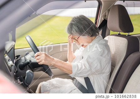 自動車の運転で事故をして困る高齢者女性 101662838
