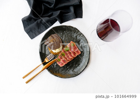 Medium roasted beef slices on a black plate Medium roasted beef slices on a black plate 101664999