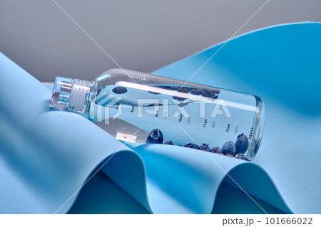 A glass bottle of pure water with blueberries. A glass bottle of pure water with blueberries. 101666022