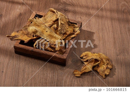 Rhubarb root and rhizome displayed on a wooden tray with wooden background. Rhubarb root and rhizome (Rhizoma Rhei) is mainly used to cure digestive problems Rhubarb root and rhizome displayed on a wooden tray with wooden background. Rhubarb root and rhizome (Rhizoma Rhei) is mainly used to cure digestive problems 101666815
