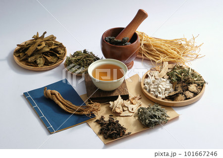 A bowl of medicine placed on a wooden podium in the center with many types of herb displayed around. Chinese medicine treat a wide range of ailments to enhance health A bowl of medicine placed on a wooden podium in the center with many types of herb displayed around. Chinese medicine treat a wide range of ailments to enhance health 101667246