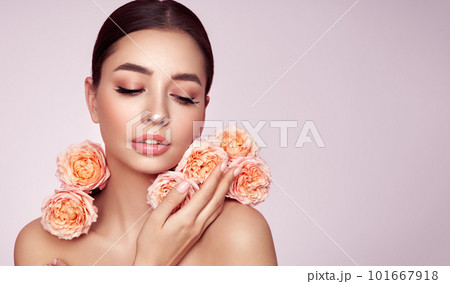 Beautiful young woman with a rose flower 101667918