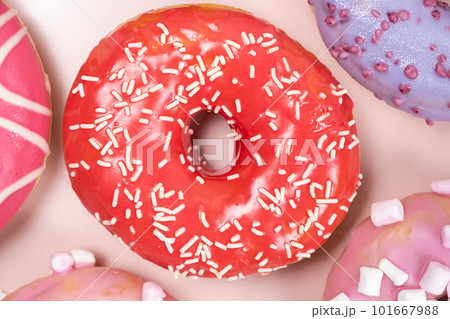 Donuts with red and pink glaze, top view. Lots of donuts, sweet and delicious food Donuts with red and pink glaze, top view. Lots of donuts, sweet and delicious food 101667988