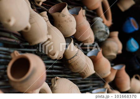 Ceramic clay terracotta jug, pot, vase, kitchen souvenirs in a handmade ceramics street store. 101668370