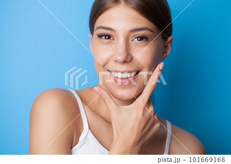 Portrait of girl with strong white teeth looking at camera and smiling 101669168
