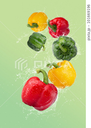 Red Bell Pepper Green Bell Pepper and Yellow Bell Pepper on a Green background 101669196