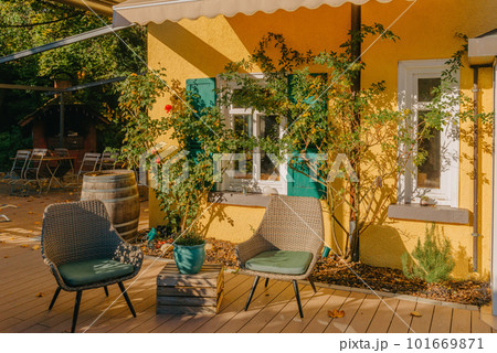 Image of a empty coffee tables arranged in backyard of a house. Autumn in Germany, Europe. Outdoor table in street cafe. autumn outdoor cafe wooden furniture old europe. Autumn photo of old-fashioned Image of a empty coffee tables arranged in backyard of a house. Autumn in Germany, Europe. Outdoor table in street cafe. autumn outdoor cafe wooden furniture old europe. Autumn photo of old-fashioned 101669871