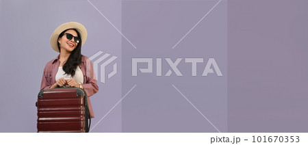 Elegant beautiful woman dressed in summer clothes with luggage isolated purple background with copy space for your graphic design Elegant beautiful woman dressed in summer clothes with luggage isolated purple background with copy space for your graphic design 101670353
