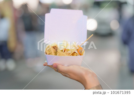 woman hand holding Stinky Tofu at night market, famous Taiwanese Street Food of Taiwan. exotic food in local market woman hand holding Stinky Tofu at night market, famous Taiwanese Street Food of Taiwan. exotic food in local market 101671395