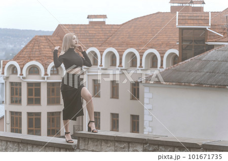 Young sexy woman stand on ancient architecture background. Stylish woman in black outfit and heels. Young sexy woman stand on ancient architecture background. Stylish woman in black outfit and heels. 101671735