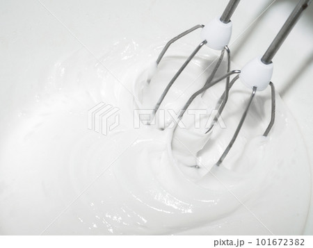 The beaters of an electric mixer beat the pastry cream from eggs and sugar. The beaters of an electric mixer beat the pastry cream from eggs and sugar. 101672382