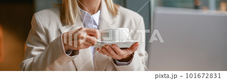 Close up of businesswoman having coffee break time during working day in cafe 101672831