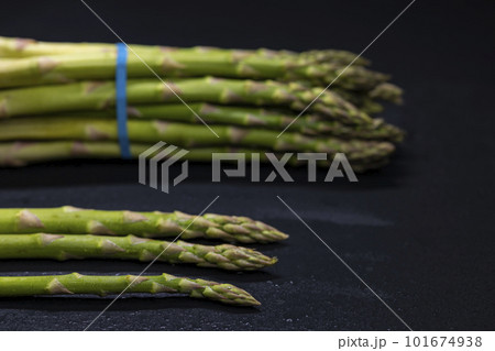Green asparagus on black background Green asparagus on black background 101674938