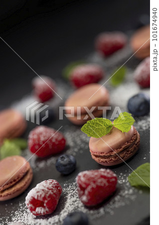 macaroons of different colors on a black background macaroons of different colors on a black background 101674940