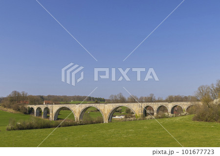 Arched stone railway bridge onabandoned railway near Cognieres, Doubs, France 101677723