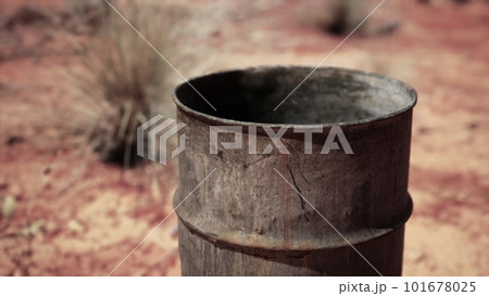 old empty rusted barrel on sand old empty rusted barrel on sand 101678025