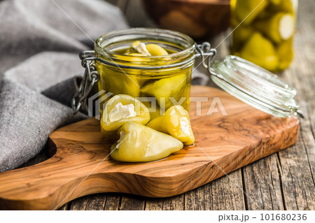 Peppers stuffed with cream cheese on cutting board. 101680236