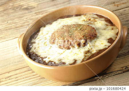 たっぷりのチーズとハンバーグが乗っている熱々焼きカレー たっぷりのチーズとハンバーグが乗っている熱々焼きカレー 101680424