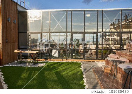The city's upscale cafe on benches is a place for public gatherings of modern recreation. Empty wooden benches on the roof of the cafe building or outside cinema. High quality photo 101680489
