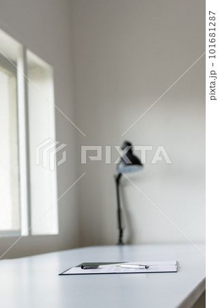 Application form and ink pen lying on white desk Application form and ink pen lying on white desk 101681287