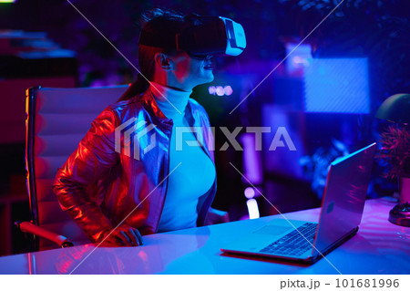 40 years old woman in virtual reality goggles in office 101681996