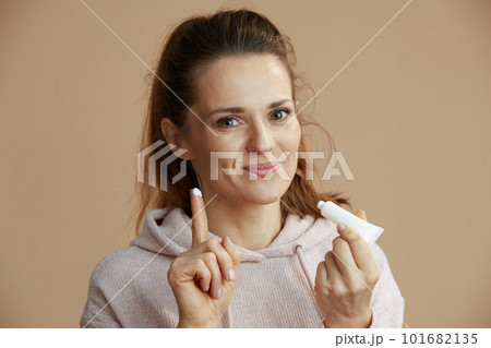 woman with herpes on lips against beige background 101682135