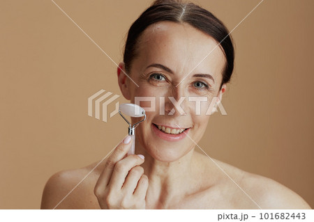 Portrait of happy modern woman against beige background Portrait of happy modern woman against beige background 101682443
