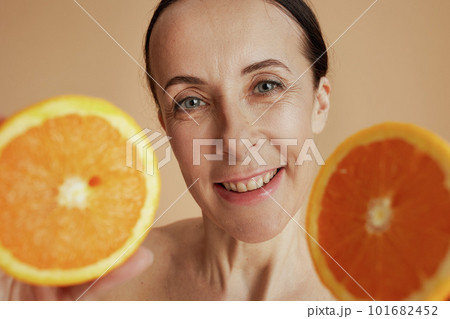 happy modern woman against beige background happy modern woman against beige background 101682452
