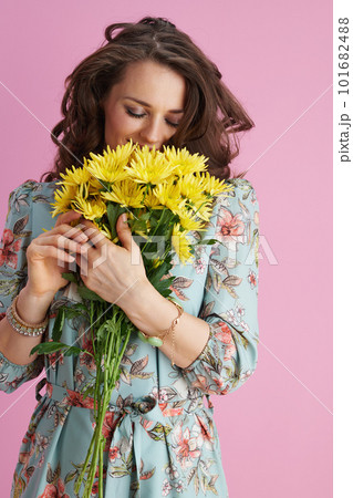 relaxed woman in floral dress on pink 101682488