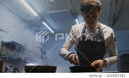 Chef sets fire and fries meat in flambe style Chef sets fire and fries meat in flambe style 101682581