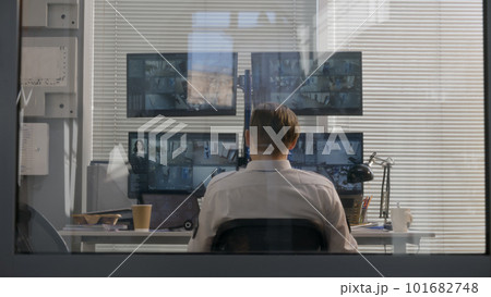 Security officer leans on back of chair at work 101682748