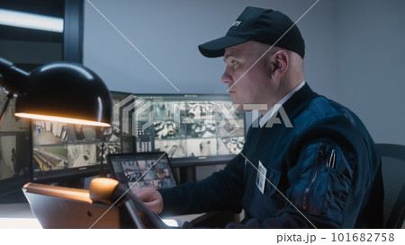 Security officer makes call by landline phone Security officer makes call by landline phone 101682758