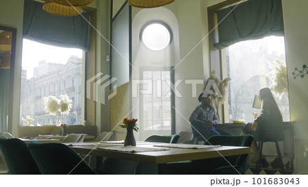Waitress prepares restaurant with modern design Waitress prepares restaurant with modern design 101683043