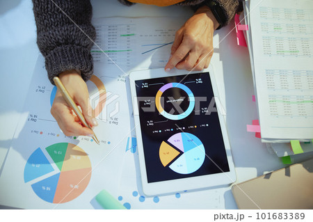 business woman with tablet pc working with documents and graphs 101683389