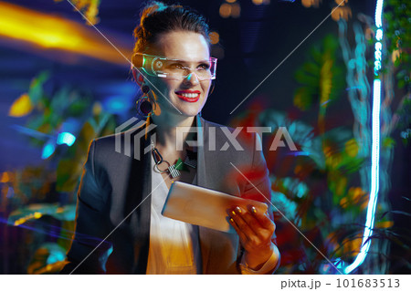 happy modern female using tablet PC in metaverse happy modern female using tablet PC in metaverse 101683513