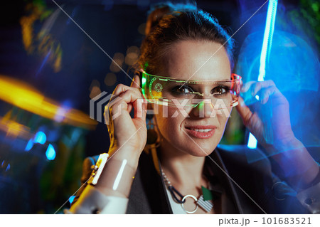 happy modern female with futuristic goggles in virtual reality 101683521