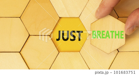 Just breathe and psychological symbol. Concept words Just breathe on wooden puzzles. Beautiful yellow table yellow background. Businessman hand. Business psychological Just breathe concept. Copy space 101683751