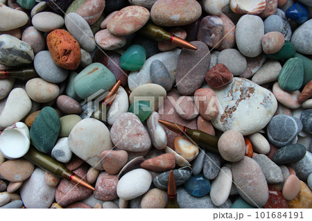Bullets For a Gun Under Smooth Colored Stones And Seashells Texture Backgrounds Bullets For a Gun Under Smooth Colored Stones And Seashells Texture Backgrounds 101684191
