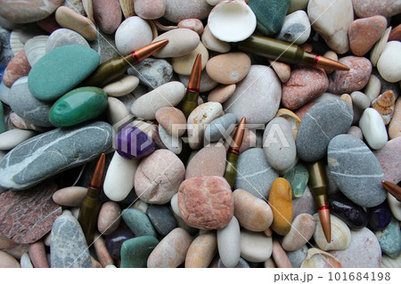 Closeup photo of unitary cartridges partially covered with colored smooth stones Closeup photo of unitary cartridges partially covered with colored smooth stones 101684198