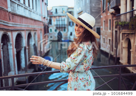 happy stylish woman in floral dress enjoying promenade 101684499