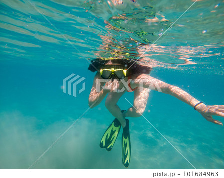woman diving underwater in scuba mask and flippers 101684963