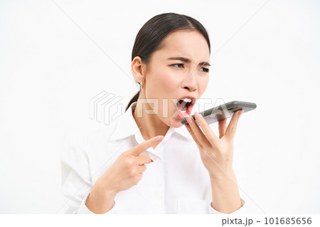 Angry korean saleswoman, shouting at smartphone speaker, screaming at mobile phone, scolding employee on cellphone, white background 101685656