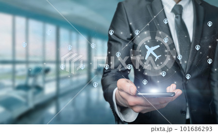 Businessman choose flight route app by phone . 101686293