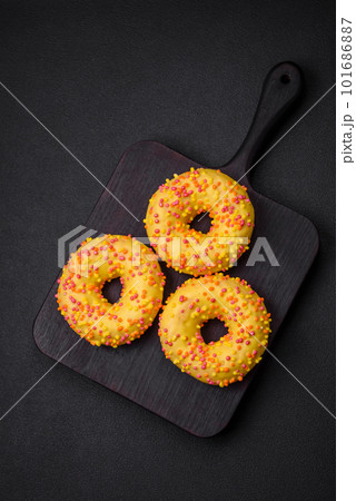 Delicious fresh donuts in yellow glaze with lemon flavor filling 101686887