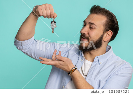 Lebanese man real estate agent showing keys of new home house apartment, buying renting property Lebanese man real estate agent showing keys of new home house apartment, buying renting property 101687523