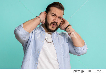 Annoyed irritated handsome man covering ears gesturing No avoiding advice ignoring noise loud voices Annoyed irritated handsome man covering ears gesturing No avoiding advice ignoring noise loud voices 101687540